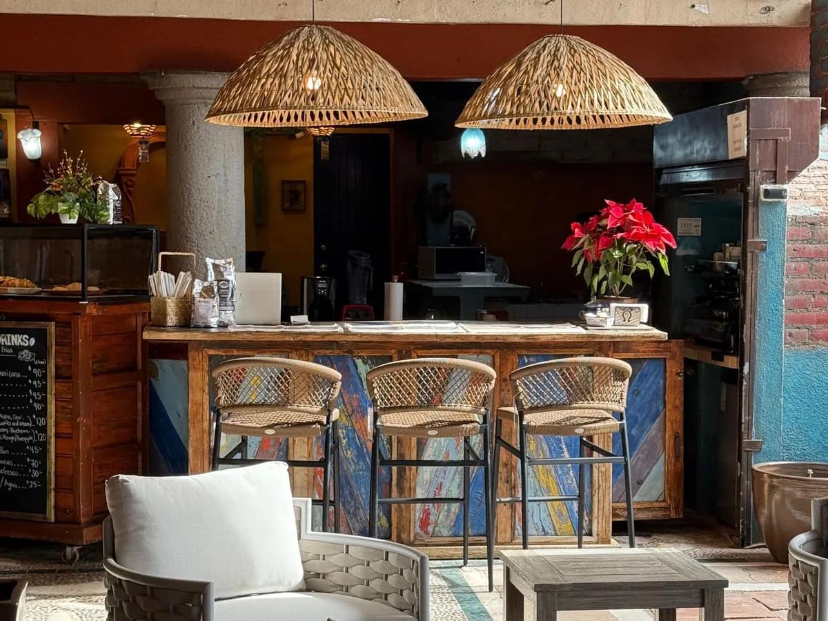 The Chalala bar with rattan stools, woven pendant lamps and a red poinsettia, lounge chairs in front