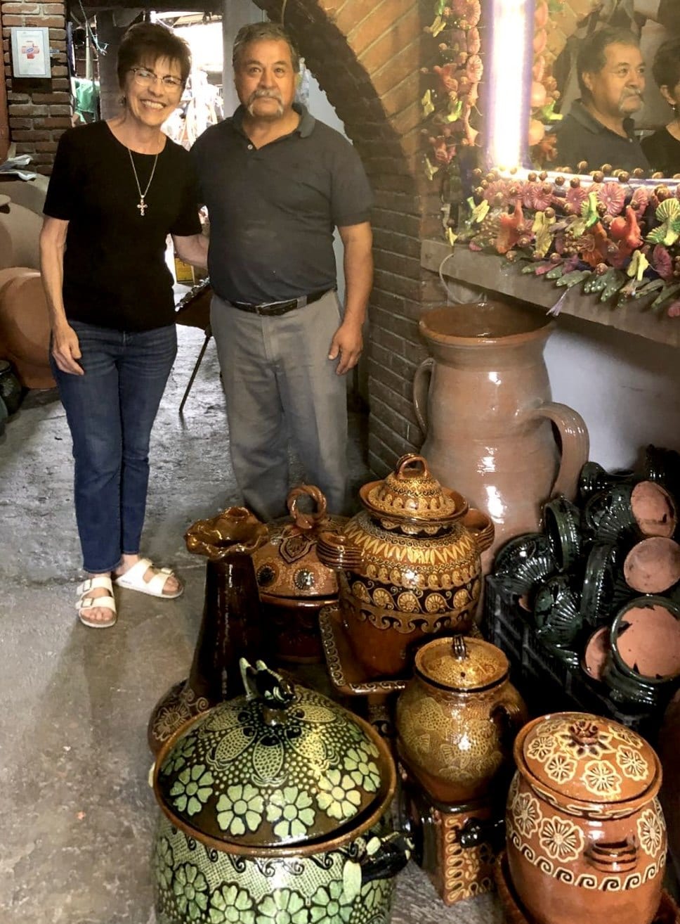 Marsha with Bernardo Camacho Quiroz in his Metepec workshop, among his glazed and hand-painted clay pieces