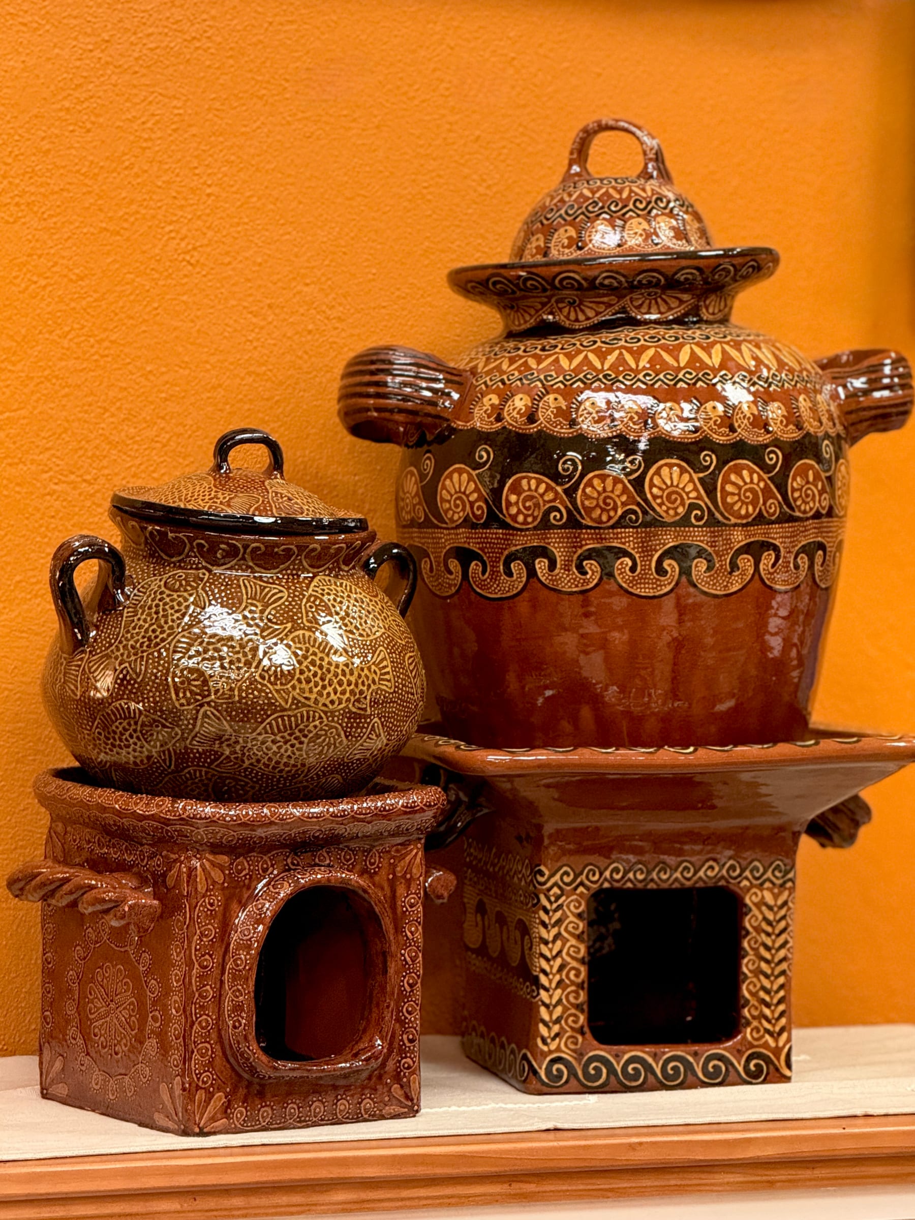 Hand-painted red clay stoves by Bernardo Camacho Quiroz