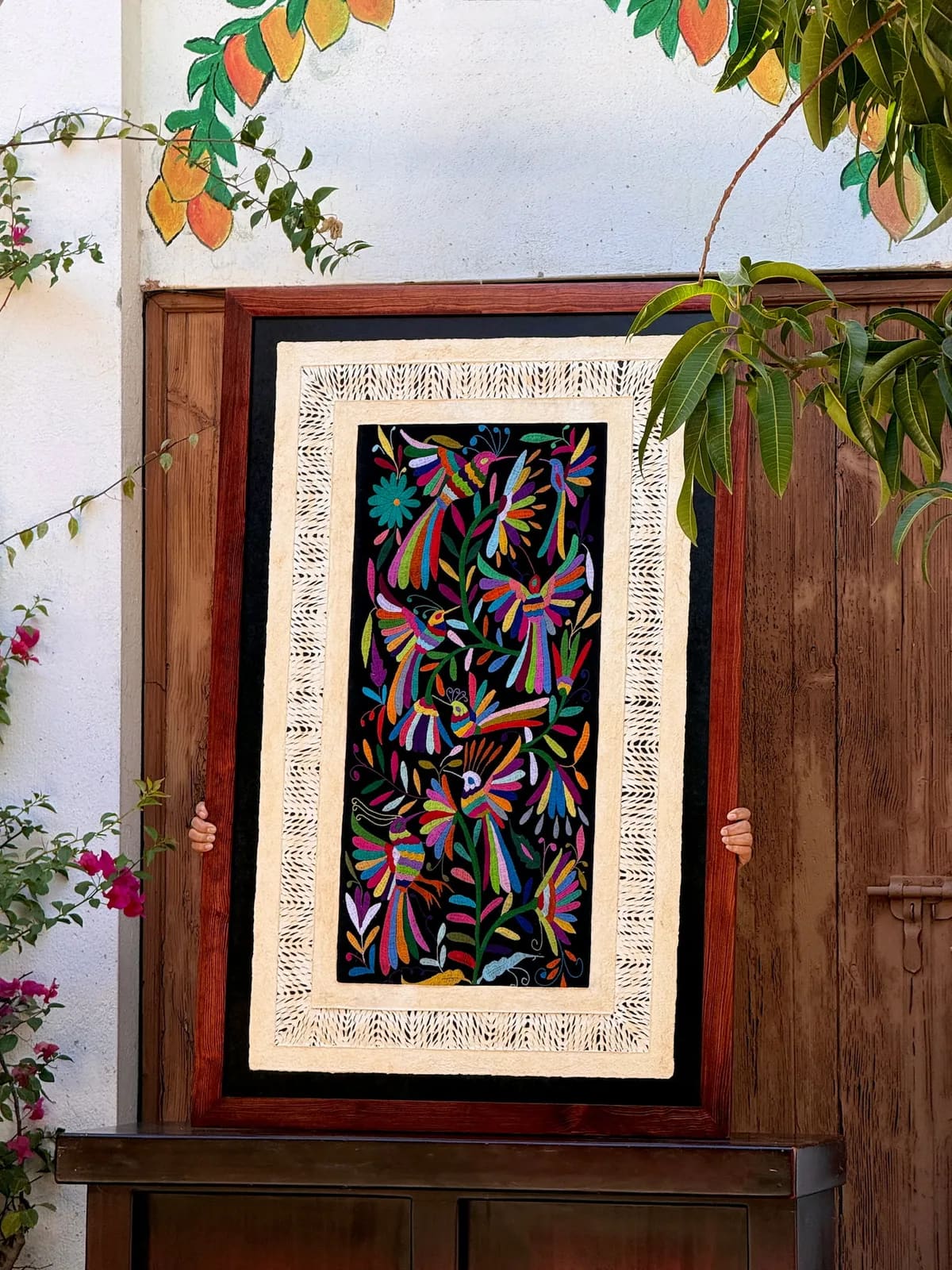 Amate Wall Art with Black Tenango Embroidery – Framed wall hanging featuring traditional amate art
