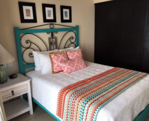 Turquoise bed frame with wrought iron details