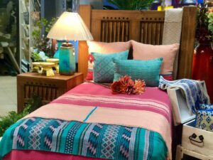 Twin bed frame, colorful bedding and pillows made in Mexico