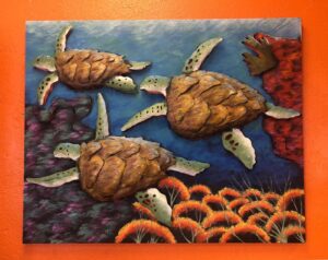 Metal wall art of turtles in the ocean