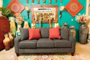 Dark gray LaZBoy talbot sofa in Cabo San Lucas with red throw pillows