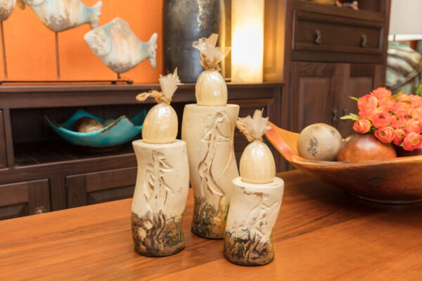 Ceramic candle holders with cave painting carvings
