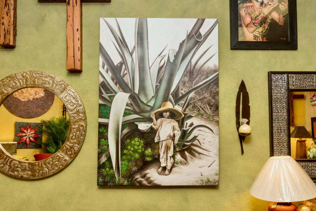 A0BACCE4-7F9E-45EE-955A-F499EABEA4AD Painting of young Mexican boy next to a agave cactus, available in Cabo San Lucas, Mexico