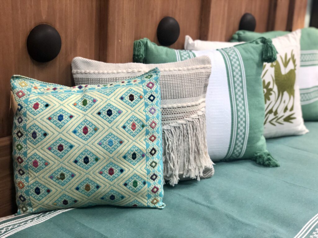 Cojines Bordados Azules Four assorted Mexican embroidered pillows in shades of green and blue in Cabo San Lucas