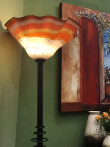Orange and white blown glass floor lamp with iron stand, for sale at a furniture store in Cabo San Lucas, Mexico