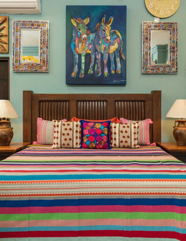 Bed with Hand-Embroidered Bedding Bed and bed frame with hand embroidered bedding and pillows at Casa Bonita