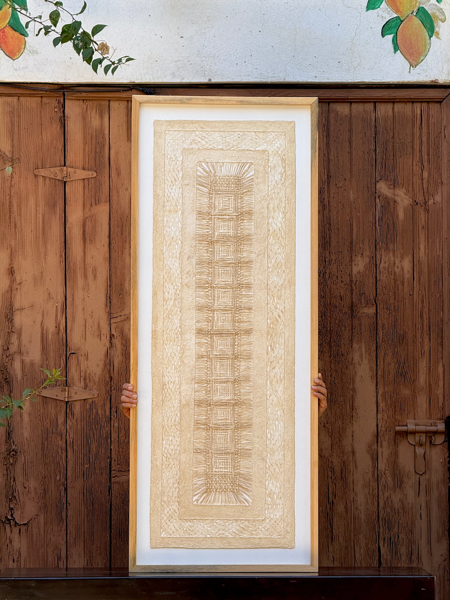 Framed wall hanging featuring traditional amate art