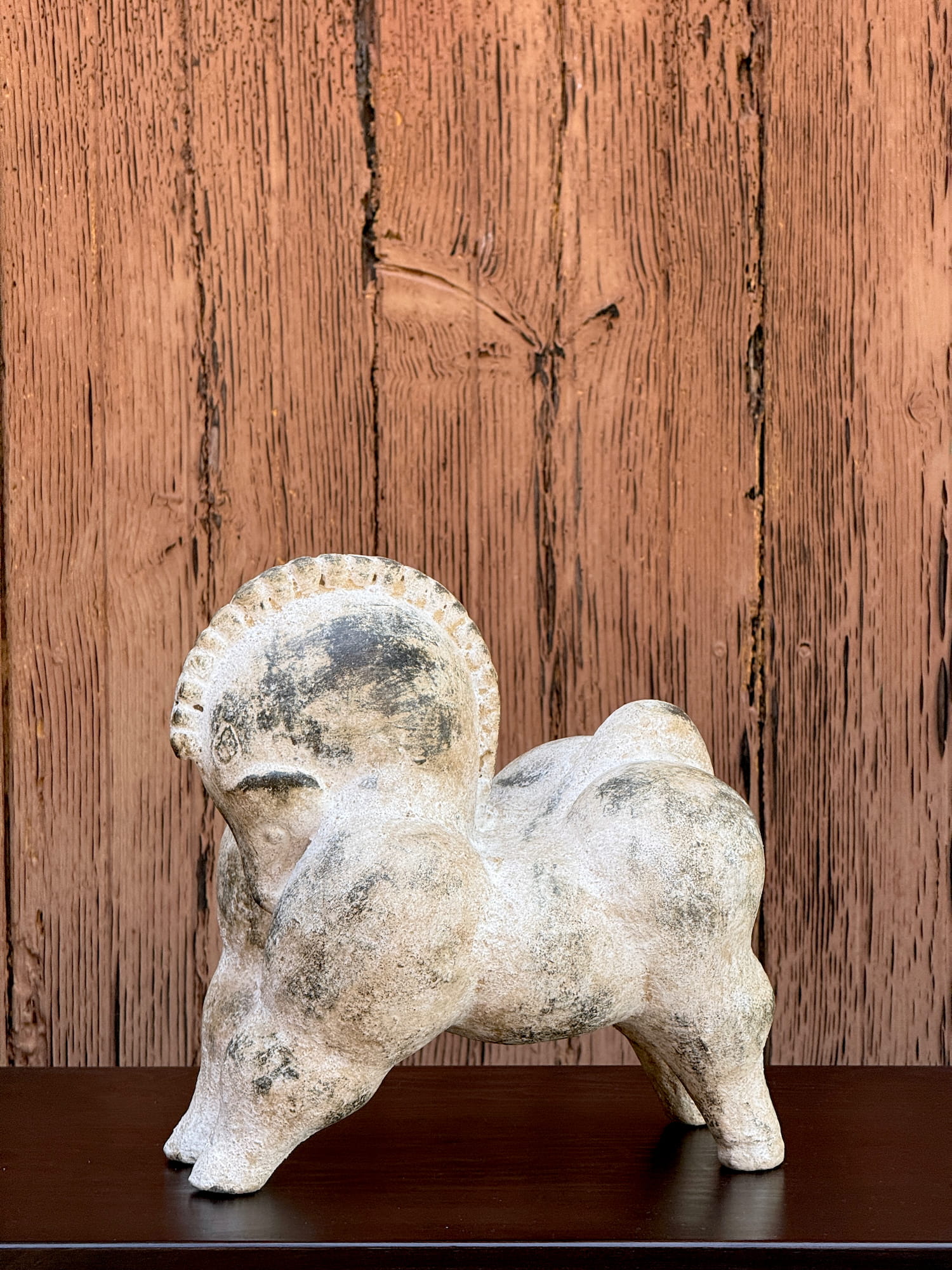 Clay horse sculpture with weathered finish