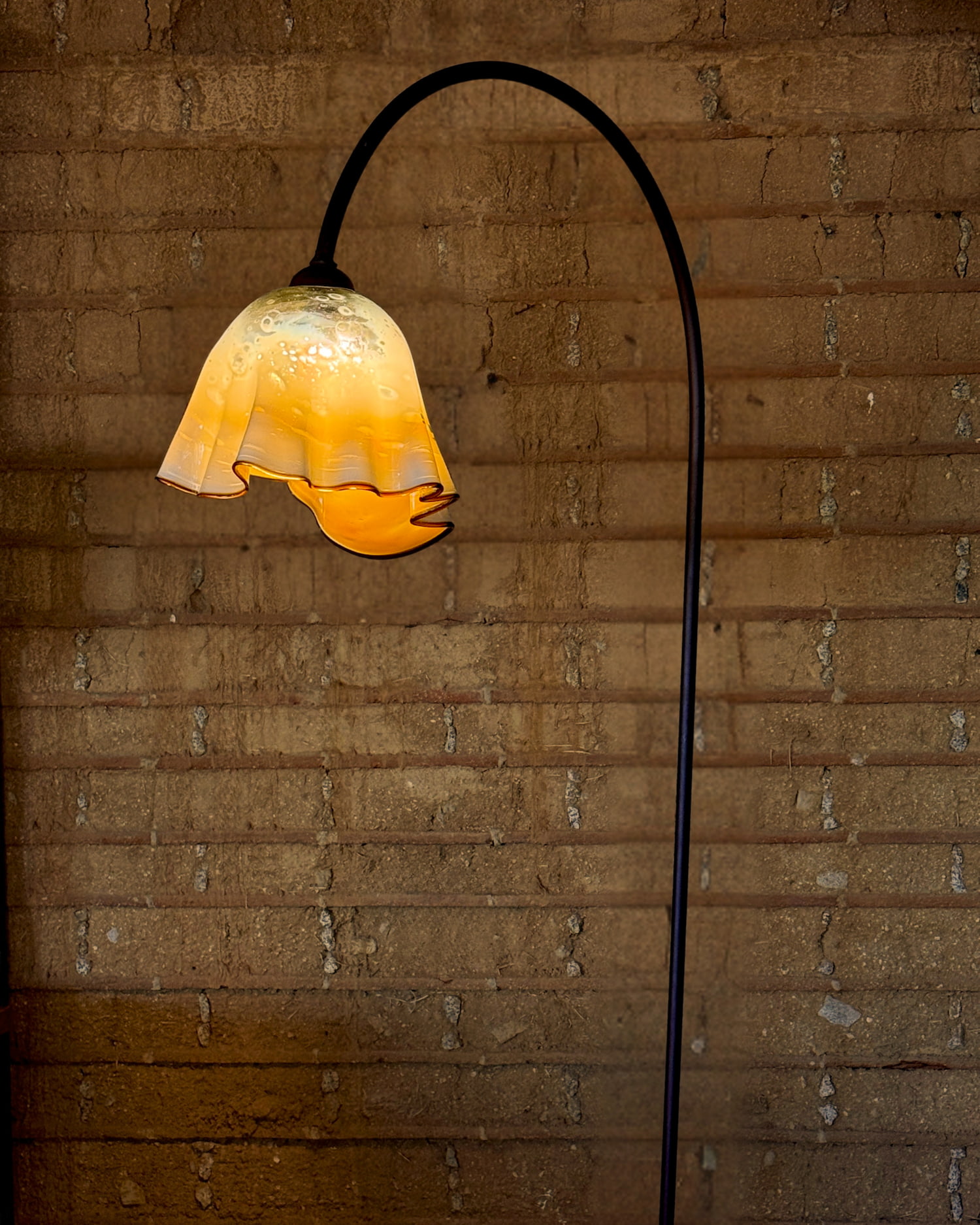 Handblown glass floor lamp in amber tones with iron base